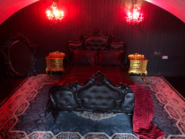 Luxurious overnight fetish experience London with a gothic-inspired bed and lavish decor