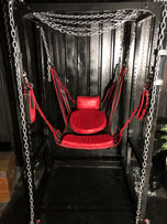Red plush seating arrangement in a metal frame for an overnight fetish experience London